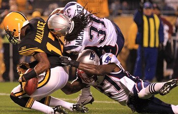 PITTSBURGH - NOVEMBER 14:  Mike Wallace #17 of the Pittsburgh Steelers drops the ball in the endzone under pressure from Brandon Meriweather #31 and Kyle Arrington #27 of the New England Patriots on November 14, 2010 at Heinz Field in Pittsburgh, Pennsylv