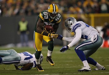 GREEN BAY, WI - NOVEMBER 07: James Jones #89 of the Green Bay Packers runs past Alan Ball #20 of the Dallas Cowboys as Barry Church #42 moves in for the tackle at Lambeau Field on November 7, 2010 in Green Bay, Wisconsin. The Packers defeated the Cowboys 