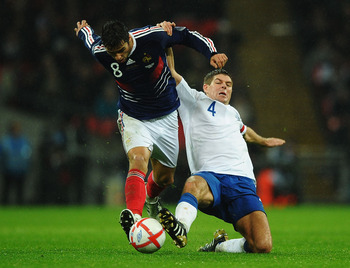 LONDON, ENGLAND - NOVEMBER 17:  Steven Gerrard of England tackles Yoann Gourcuff of France during the international friendly match between England and France at Wembley Stadium on November 17, 2010 in London, England.  (Photo by Laurence Griffiths/Getty I