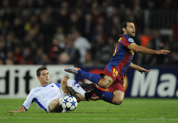 BARCELONA, SPAIN - OCTOBER 20:  Martin Vingaard of FC Copenhagen (L) and Javier Mascherano of Barcelona duels for a ball during the UEFA Champions League group D match between Barcelona and FC Copenhagen at the Camp nou stadium on October 20, 2010 in Barc