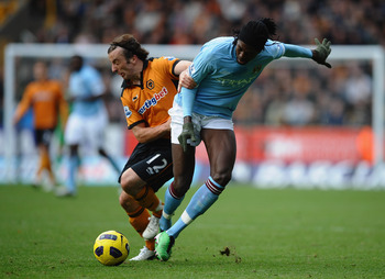 WOLVERHAMPTON, ENGLAND - OCTOBER 30:  Emmanuel Adebayor of Manchester City battles with Stephen Hunt of Wolves during the Barclays Premier League match between Wolverhampton Wanderers and Manchester City at Molineux on October 30, 2010 in Wolverhampton, E