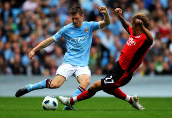 MANCHESTER, ENGLAND - SEPTEMBER 11:  James Milner of Manchester City is challenged by Michel Salgado of Blackburn Rovers during the Barclays Premier League match between Manchester City and Blackburn Rovers at the City of Manchester Stadium on September 1