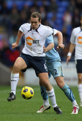 BOLTON, ENGLAND - NOVEMBER 06:  Kevin Davies of Bolton Wanderers holds off a challenge from Alan Hutton of Tottenham Hotspur during the Barclays Premier League match between Bolton Wanderers and Tottenham Hotspur at the Reebok Stadium on November 6, 2010 