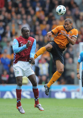 WOLVERHAMPTON, ENGLAND - SEPTEMBER 26: Karl Henry of Wolves in action with Emile Heskey of Aston Villa during the Barclays Premier League match between Wolverhampton Wanderers and Aston Villa at Molineux on September 26, 2010 in Wolverhampton, England.  (