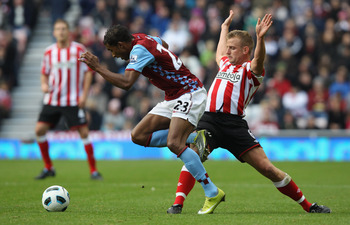 SUNDERLAND, ENGLAND - OCTOBER 23:  Habib Baye  of Aston Villa leaps over a challenge from Lee Cattermole of Sunderland during the Barclays Premier League match between Sunderland and Aston Villa at Stadium of Light on October 23, 2010 in Sunderland, Engla