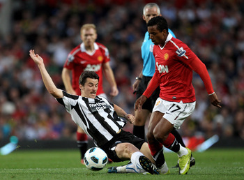 MANCHESTER, ENGLAND - AUGUST 16:  Joey Barton of Newcastle United tackles Nani of Manchester United during the Barclays Premier League match between Manchester United and Newcastle United at Old Trafford on August 16, 2010 in Manchester, England.  (Photo 