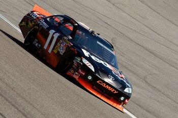 HOMESTEAD, FL - NOVEMBER 21:  Denny Hamlin, driver of the #11 FedEx Toyota, drives after sustaining front end damage during the NASCAR Sprint Cup Series Ford 400 at Homestead-Miami Speedway on November 21, 2010 in Homestead, Florida.  (Photo by Sam Greenw