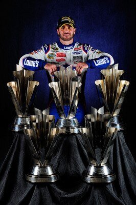 HOMESTEAD, FL - NOVEMBER 21:  NASCAR Champion Jimmie Johnson, driver of the #48 Lowe's Chevrolet, poses with the Sprint Cup Series Championship trophies at Homestead-Miami Speedway on November 21, 2010 in Homestead, Florida. Johnson clinched his fifth str