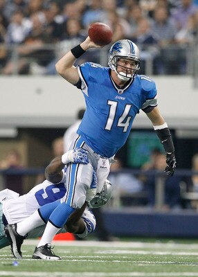 ARLINGTON, TX - NOVEMBER 21: Shaun Hill #14 of the Detroit Lions throws the ball as DeMarcus Ware #94 of the Dallas Cowboys makes the sack during the game at Dallas Stadium on November 21, 2010 in Arlington, Texas. The Cowboys defeated the Lions 35-19.  (