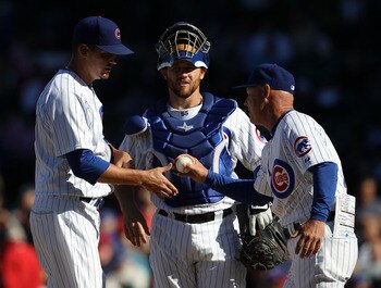 CHICAGO - SEPTEMBER 24: Interim manager Mike Quade #8 of the Chicago Cubs takes pitcher Scott Maine #57 out of a game against the St. Louis Cardinals as Koyie Hill #55 watches at Wrigley Field on September 24, 2010 in Chicago, Illinois. The CArdinals defe