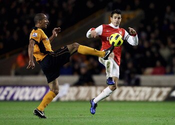 WOLVERHAMPTON, ENGLAND - NOVEMBER 10:  Karl Henry of Wolverhampton (L) in action with Cesc Fabregas of Arsenal during the Barclays Premier League match between Wolverhampton Wanderers and Arsenal, at Molineux on November 10, 2010 in Wolverhampton, England