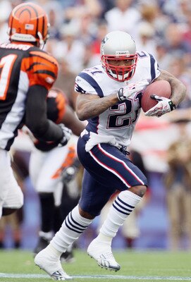 FOXBORO, MA - SEPTEMBER 12:  Fred Taylor #21 of the New England Patriots carries the ball as Roy Williams #31 defends during the NFL season opener on September 12, 2010 at Gillette Stadium in Foxboro, Massachusetts. The Patriots defeated the Bengals 38-24