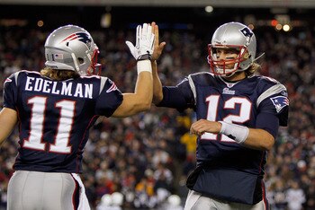 FOXBORO, MA - NOVEMBER 21: Tom Brady #12 of the New England Patriots reacts with teammate Julian Edelman #11 after a touchdown in the second half at Gillette Stadium on November 21, 2010 in Foxboro, Massachusetts. (Photo by Jim Rogash/Getty Images)