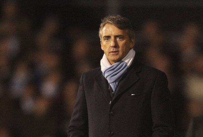LONDON, ENGLAND - NOVEMBER 21:  Manchester City manager Roberto Mancini looks on with Fulham manager Mark Hughes during the Barclays Premier League match between Fulham and Manchester City at Craven Cottage on November 21, 2010 in London, England.  (Photo