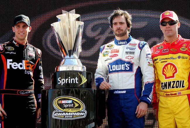 HOMESTEAD, FL - NOVEMBER 21:  (L-R) Denny Hamlin, driver of the #11 FedEx Toyota, stands next to the Sprint Cup trophy with Jimmie Johnson, driver of the #48 Lowe's Chevrolet, and Kevin Harvick, driver of the #29 Shell/Pennzoil Chevrolet, during the NASCA