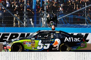 AVONDALE, AZ - NOVEMBER 14:  Carl Edwards, driver of the #99 Aflac Ford, performs a backflip after winning the NASCAR Sprint Cup Series Kobalt Tools 500 at Phoenix International Raceway on November 14, 2010 in Avondale, Arizona.  (Photo by Jason Smith/Get