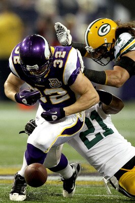 MINNEAPOLIS - NOVEMBER 21:  Toby Gerhart #32 of the Minnesota Vikings has the ball jarred loose by Charles Woodson #21 and Brandon Chillar #54 of the Green Bay Packers at the Hubert H. Humphrey Metrodome on November 21, 2010 in Minneapolis, Minnesota.  (P