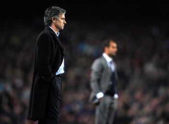 BARCELONA, SPAIN - NOVEMBER 24:  Coach Jose Mourinho of Inter Milan follows his players backdropped by coach Josep Guardiola of FC Barcelona during the UEFA Champions League group F match between FC Barcelona and Inter Milan at the Camp Nou Stadium on Nov