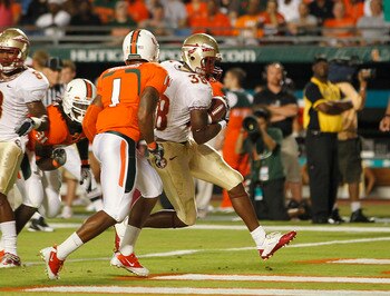 MIAMI, FL - OCTOBER 9: Jermaine Thomas #38 of the Florida State Seminoles eludes the tackle of Brandon Harris #1 of the Miami Hurricanes to score a touchdown on October 9, 2010 at Sun Life Stadium in Miami, Florida. (Photo by Joel Auerbach/Getty Images)