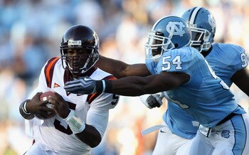 CHAPEL HILL, NC - NOVEMBER 13:  Tyrod Taylor #5 of the Virginia Tech Hokies is tackled by Bruce Carter #54 and teammate Jared McAdoo #97 of the North Carolina Tar Heels during their game at Kenan Stadium on November 13, 2010 in Chapel Hill, North Carolina
