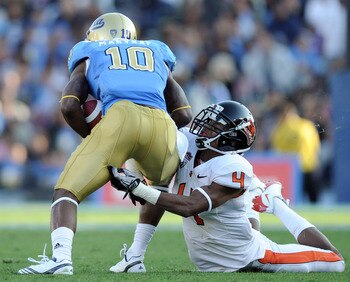 PASADENA, CA - NOVEMBER 06:  James Dockery #4 of the Oregon State Beavers attempts to tackle Akeem Ayers #10 of the UCLA Bruins after a catch at the Rose Bowl on November 6, 2010 in Pasadena, California.  (Photo by Harry How/Getty Images)