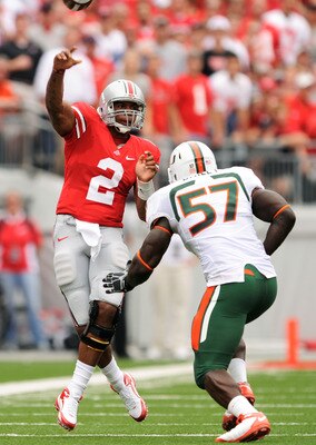 COLUMBUS, OH - SEPTEMBER 11:  Quarterback Terrelle Pryor #2 of the Ohio State Buckeyes gets off a pass as Allen Bailey #57 of the Miami Hurricanes applies pressure at Ohio Stadium on September 11, 2010 in Columbus, Ohio.  (Photo by Jamie Sabau/Getty Image