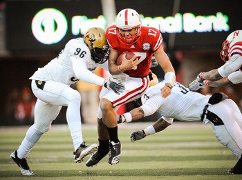 LINCOLN, NE - NOVEMBER 26: Cody Green #17 of the Nebraska Cornhuskers takes a hit from Chidera Uzo-Diribe #96 and Jimmy Smith #3 of the Colorado Buffaloes during the first half of their game at Memorial Stadium on November 26, 2010 in Lincoln, Nebraska.