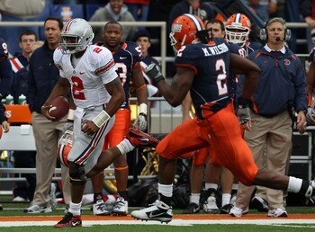 CHAMPAIGN, IL - OCTOBER 02: Terrelle Pryor #2 of the Ohio State Buckeyes runs for a first down as Martez Wilson #2 of the Illinois Fighting Illini pursues at Memorial Stadium on October 2, 2010 in Champaign, Illinois. Ohio State defeated Illinois 24-13. (
