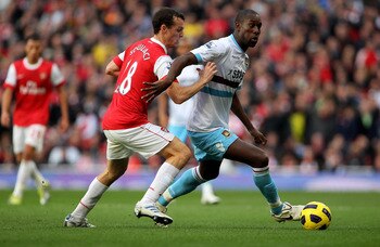 LONDON, ENGLAND - OCTOBER 30: Sebastien Squillaci of Arsebal challenges Carlton Cole during the Barclays Premier League match between Arsenal and West Ham United at Emirates Stadium on October 30, 2010 in London, England.  (Photo by Clive Rose/Getty Image