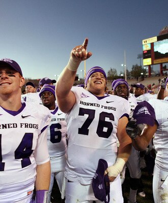 ALBUQUERQUE, NM - NOVEMBER 27: TCU Horned Frogs quarterback Andy Dalton #14, center Jake Kirkpatrick #76 and wide receiver Alonzo Adams #81 celebrate their 66-17 win over the University of New Mexico Lobos on November 27, 2010 at University Stadium in Alb