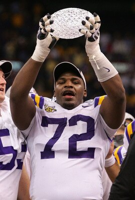 NEW ORLEANS - JANUARY 07: Glenn Dorsey #72 of the Louisiana State University Tigers raises the trophy after defeating the Ohio State Buckeyes 38-24 in the AllState BCS National Championship on January 7, 2008 at the Louisiana Superdome in New Orleans, Lou