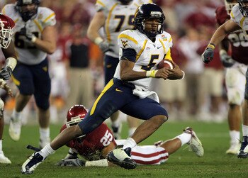 GLENDALE, AZ - JANUARY 02:  Quarterback Patrick White #5 of the West Virginia Mountaineers runs for seven-yards past D.J. Wolfe #25 of the Oklahoma Sooners in the second half at the Tostito's Fiesta Bowl at University of Phoenix Stadium January 2, 2008 in