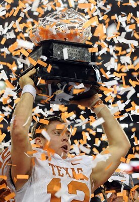 ARLINGTON, TX - DECEMBER 05:  Quarterback Colt McCoy #12 of the Texas Longhorns lifts the Big 12 Championship trophy at Cowboys Stadium on December 5, 2009 in Arlington, Texas.  (Photo by Ronald Martinez/Getty Images)