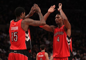 NEW YORK - JANUARY 28:  Chris Bosh #4 of the Toronto Raptors celebrates a basket with teammate Amir Johnson #15 against the New York Knicks at Madison Square Garden on January 28, 2010 in New York, New York. NOTE TO USER: User expressly acknowledges and a