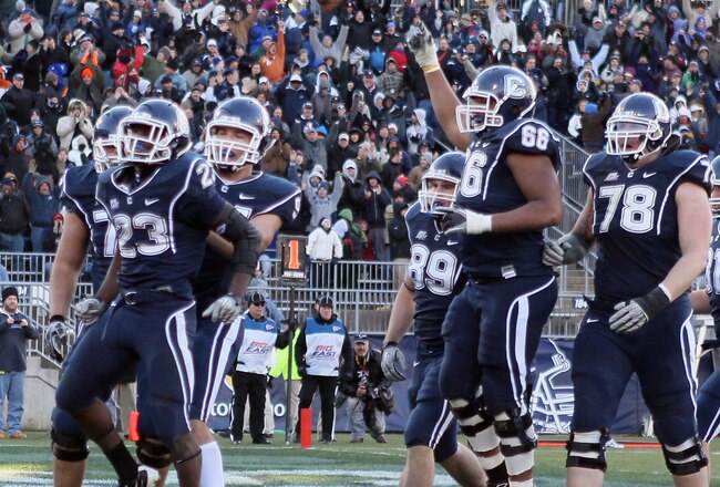 EAST HARTFORD, CT - NOVEMBER 27:  Jordan Todman #23 of the Connecticut Huskies celebrates his touchdown with teammates Ryan Griffin #94, Kevin Friend #77 and Mathieu Olivier #66 in the fourth quarter against the Cincinnati Bearcats on November 27, 2010 at