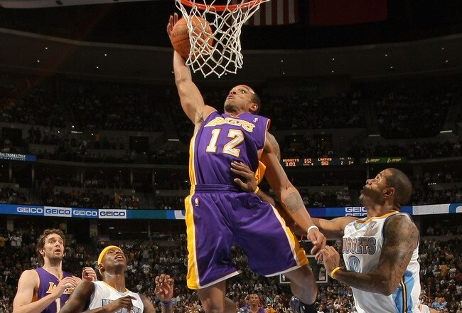 DENVER - NOVEMBER 11:  Shannon Brown #12 of the Los Angeles Lakers grabs a rebound and dunks the ball between Al Harrington #7 and Gary Forbes #0 of the Denver Nuggets at the Pepsi Center on November 11, 2010 in Denver, Colorado. The Nuggets defeated the