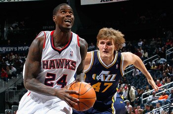 ATLANTA - NOVEMBER 12:  Marvin Williams #24 of the Atlanta Hawks drives around Andrei Kirilenko #47 of the Utah Jazz at Philips Arena on November 12, 2010 in Atlanta, Georgia.  NOTE TO USER: User expressly acknowledges and agrees that, by downloading and/