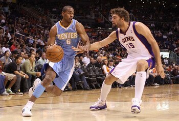 PHOENIX - OCTOBER 22:  Arron Afflalo #6 of the Denver Nuggets drives the ball against Robin Lopez #15 of the Phoenix Suns during the preseason NBA game at US Airways Center on October 22, 2010 in Phoenix, Arizona. NOTE TO USER: User expressly acknowledges
