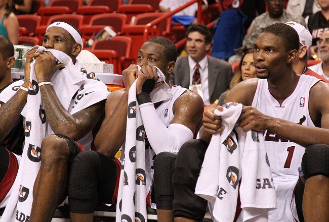 MIAMI, FL - NOVEMBER 29:  LeBron James #6, Dwyane Wade #3, and Chris Bosh #1 of the Miami Heat sit on the bench during a game against the Washington Wizards at American Airlines Arena on November 29, 2010 in Miami, Florida. NOTE TO USER: User expressly ac