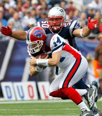 FOXBORO, MA - SEPTEMBER 26:  Rob Ninkovich #50 of the New England Patriots tackles quarterback Ryan Fitzpatrick #14 of the Buffalo Bills at Gillette Stadium on September 26, 2010 in Foxboro, Massachusetts. (Photo by Jim Rogash/Getty Images)