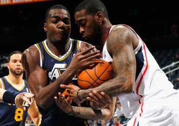 ATLANTA - NOVEMBER 12:  Josh Powell #12 of the Atlanta Hawks battles for a rebound against Paul Millsap #24 of the Utah Jazz at Philips Arena on November 12, 2010 in Atlanta, Georgia.  NOTE TO USER: User expressly acknowledges and agrees that, by download