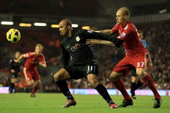 LIVERPOOL, ENGLAND - DECEMBER 06:  Gabriel Agbonlahor of Aston Villa holds off Martin Skrtel of Liverpool during the Barclays Premier League match between Liverpool and Aston Villa at Anfield on December 6, 2010 in Liverpool, England. (Photo by Mark Thomp
