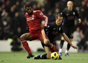LIVERPOOL, ENGLAND - DECEMBER 06:  Ryan Babel of Liverpool tangles with Jonathan Hogg of Aston Villa during the Barclays Premier League match between Liverpool and Aston Villa at Anfield on December 6, 2010 in Liverpool, England.  (Photo by Mark Thompson/
