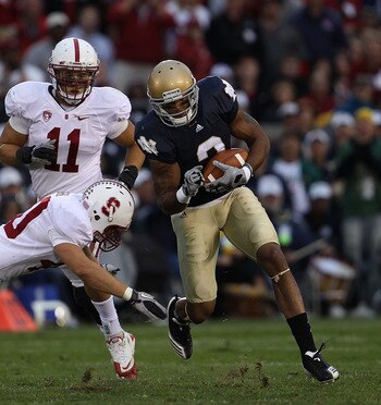 SOUTH BEND, IN - SEPTEMBER 25: Taylor Skaufel #40 of the Stanford Cardinal moves to tackle Michael Floyd #3 of the Notre Dame Fighting Irish as Shayne Skov #11 closes in at Notre Dame Stadium on September 25, 2010 in South Bend, Indiana. Stanford defeated