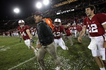 PALO ALTO, CA - NOVEMBER 27:  Head coach Jim Harbaugh of the Stanford Cardinal is covered with water from a Gatorade cooler by Andrew Luck #12 and Chike Amajoyi #43 after the Cardinal beat the Oregon State Beavers at Stanford Stadium on November 27, 2010