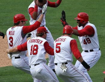 ANAHEIM, CA - SEPTEMBER 29:  Torii Hunter #48 of the Los Angeles Angels of Anaheim is mobbed by Brandon Wood #3, Kevin Frandsen #18, and Jeff Mathis #5 after Hunter's walk off single in the 11th inning ended the game with the Oakland Athletics on Septembe