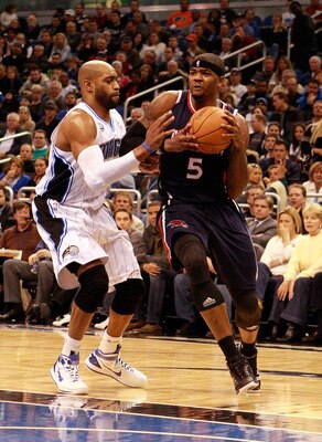 ORLANDO, FL - DECEMBER 06:  Josh Smith #5 of the Atlanta Hawks drives against Vince Carter#15 of the Orlando Magic during the game at Amway Arena on December 6, 2010 in Orlando, Florida. NOTE TO USER: User expressly acknowledges and agrees that, by downlo
