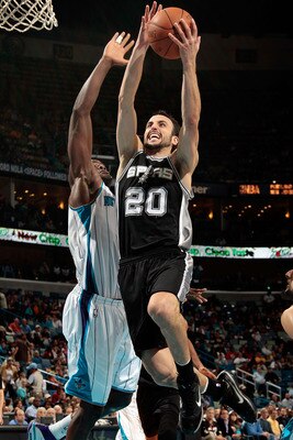 NEW ORLEANS - NOVEMBER 28:  Manu Ginobili #20 of the San Antonio Spurs shoots the ball over Emeka Okafor #50 of the New Orleans Hornets at the New Orleans Arena on November 28, 2010 in New Orleans, Louisiana.  The Spurs defeated the Hornets 109-95.  NOTE