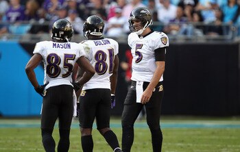 CHARLOTTE, NC - NOVEMBER 21:  Joe Flacco #5 of the Baltimore Ravens talks to his wide receivers Derrick Mason #85 and Anquan Boldin #81 during a timeout against the Carolina Panthers at Bank of America Stadium on November 21, 2010 in Charlotte, North Caro