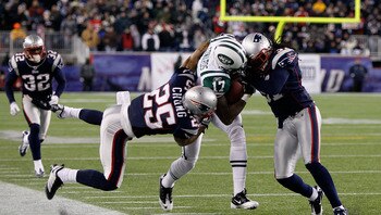 FOXBORO, MA - DECEMBER 06:  Braylon Edwards #17 of the New York Jets is hit as he runs for yards after the catch by Patrick Chung #25 and Brandon Meriweather #31 of the New England Patriots at Gillette Stadium on December 6, 2010 in Foxboro, Massachusetts